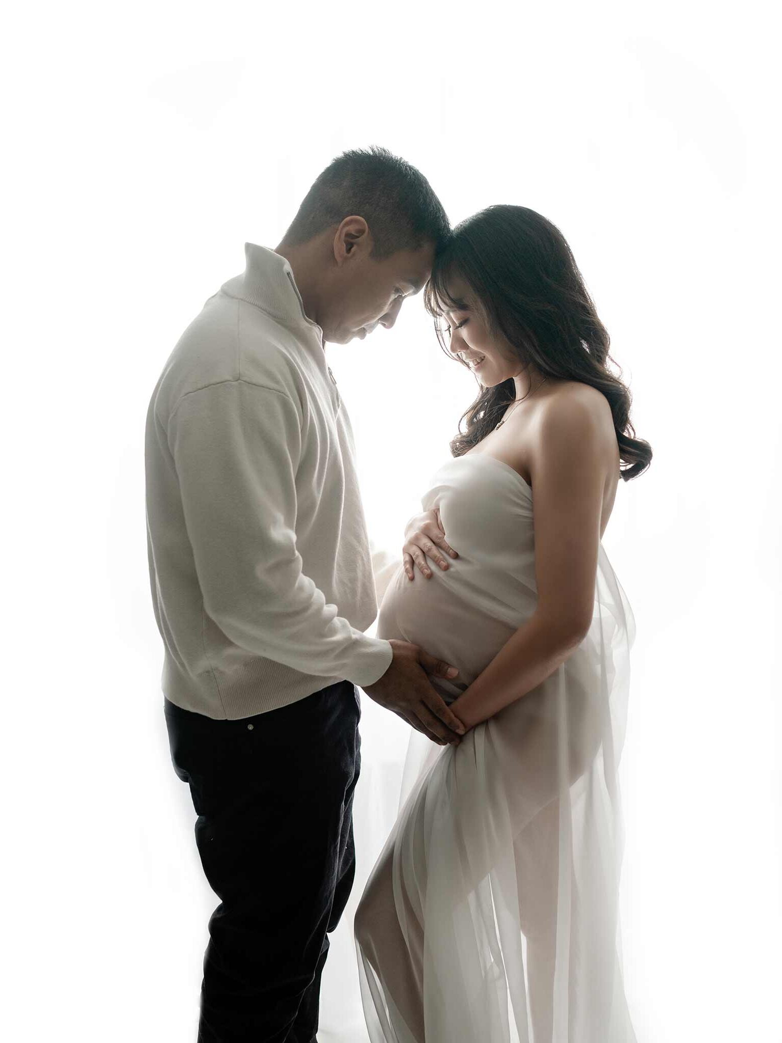 Calgary pregnant picture, couple photos, husband and wife holding pregnant belly for maternity photoshoot