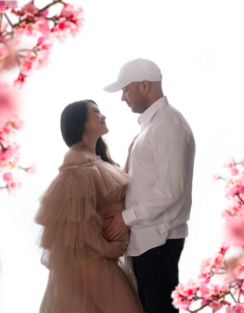 Couple looking at each other, posing for a maternity photoshoot in Calgary