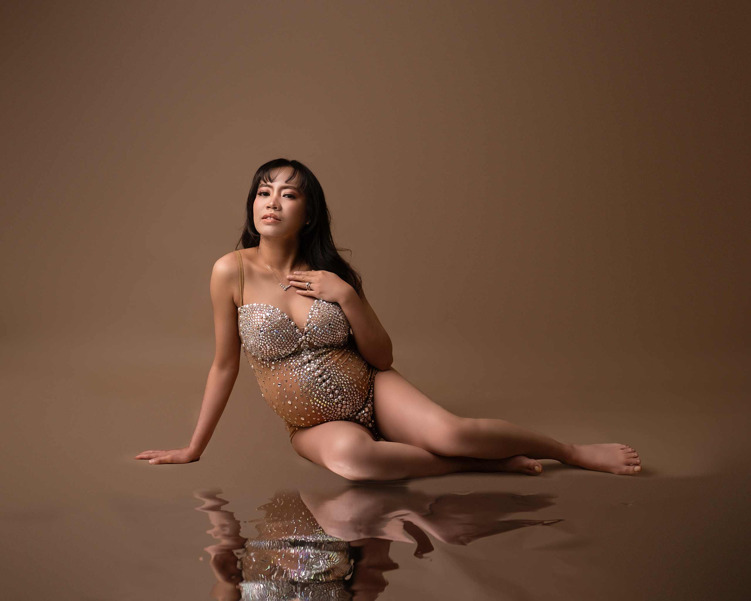 Calgary Maternity photoshoot, pregnant woman sitting on the floor with bodysuit