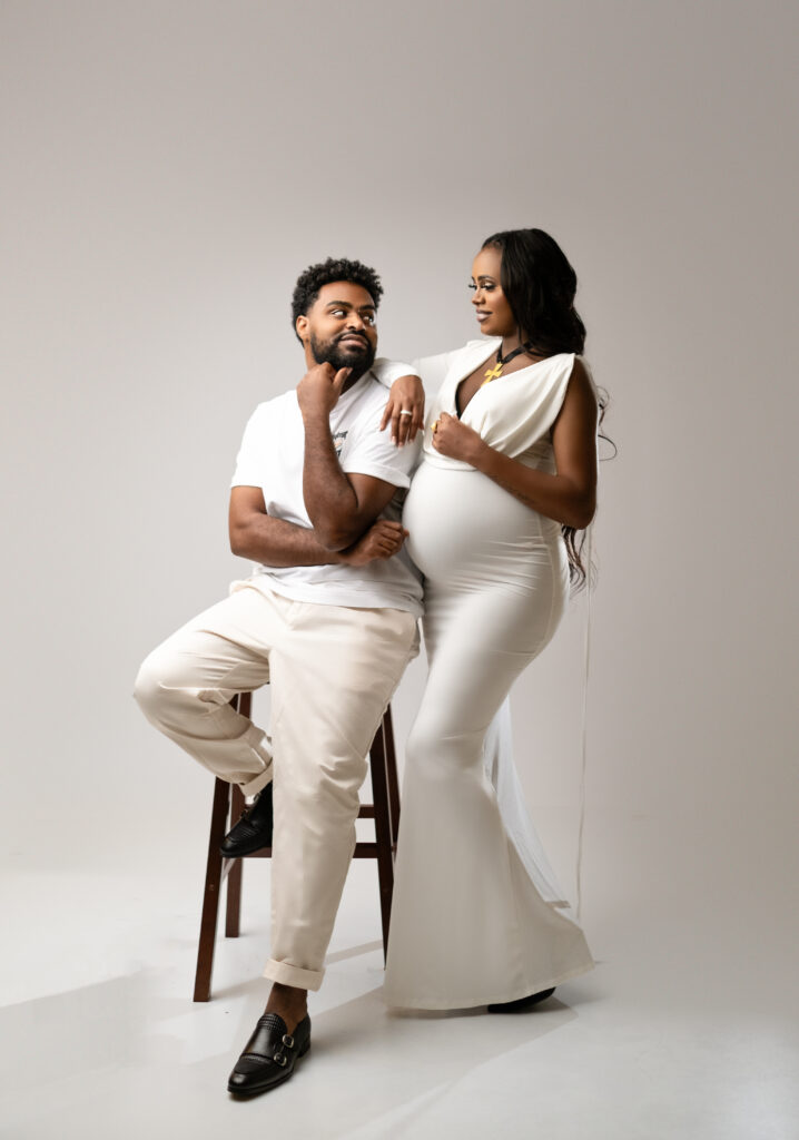 Couple looking at each other, posing for a maternity photoshoot in Calgary