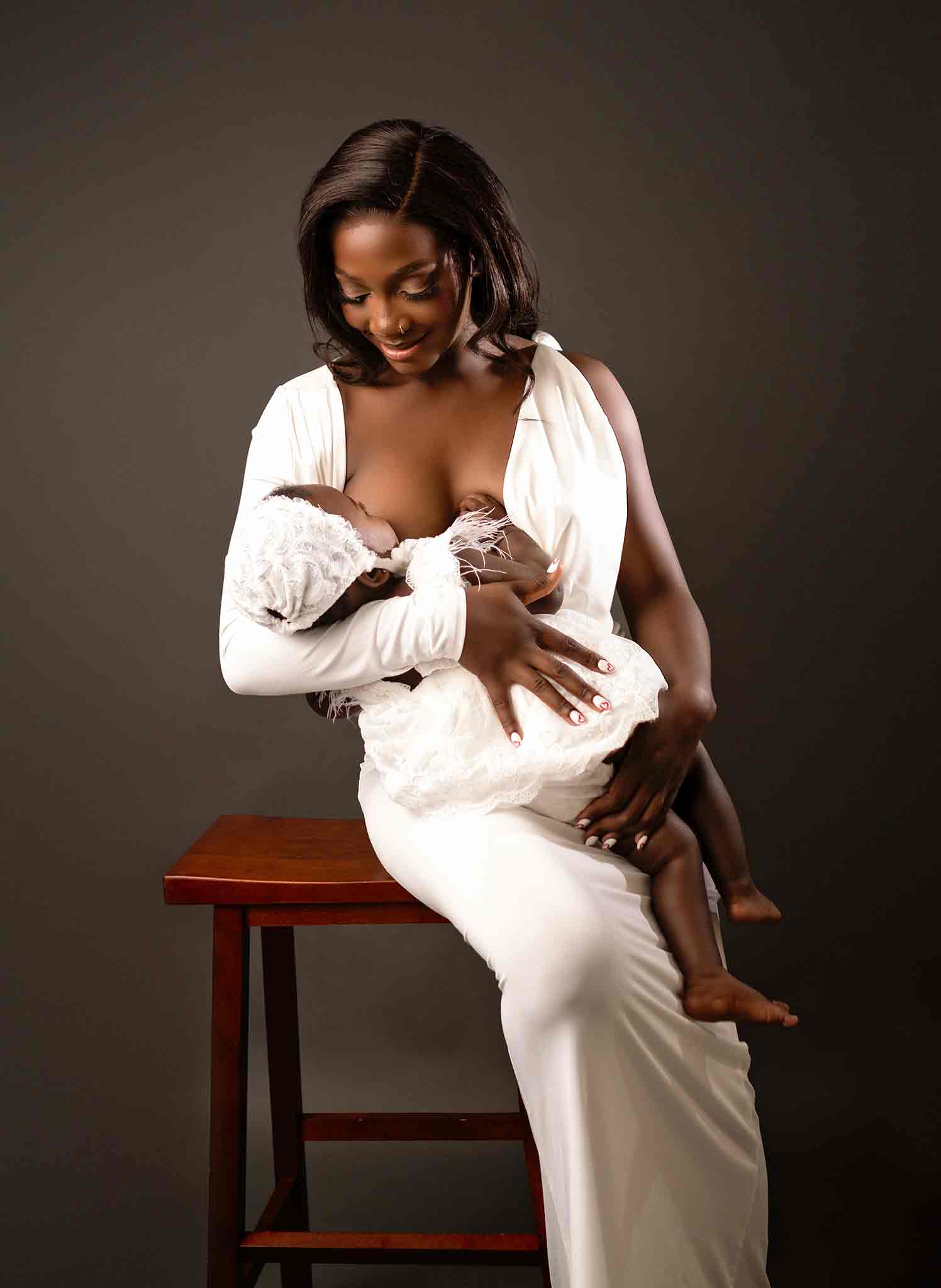 A woman breastfeeding her baby for a photoshoot in Calgary