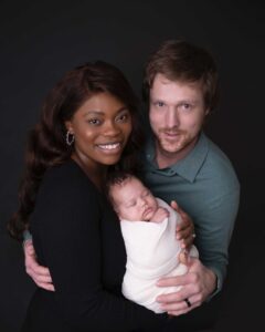 Family of three posing for their newborn photography session in Calgary