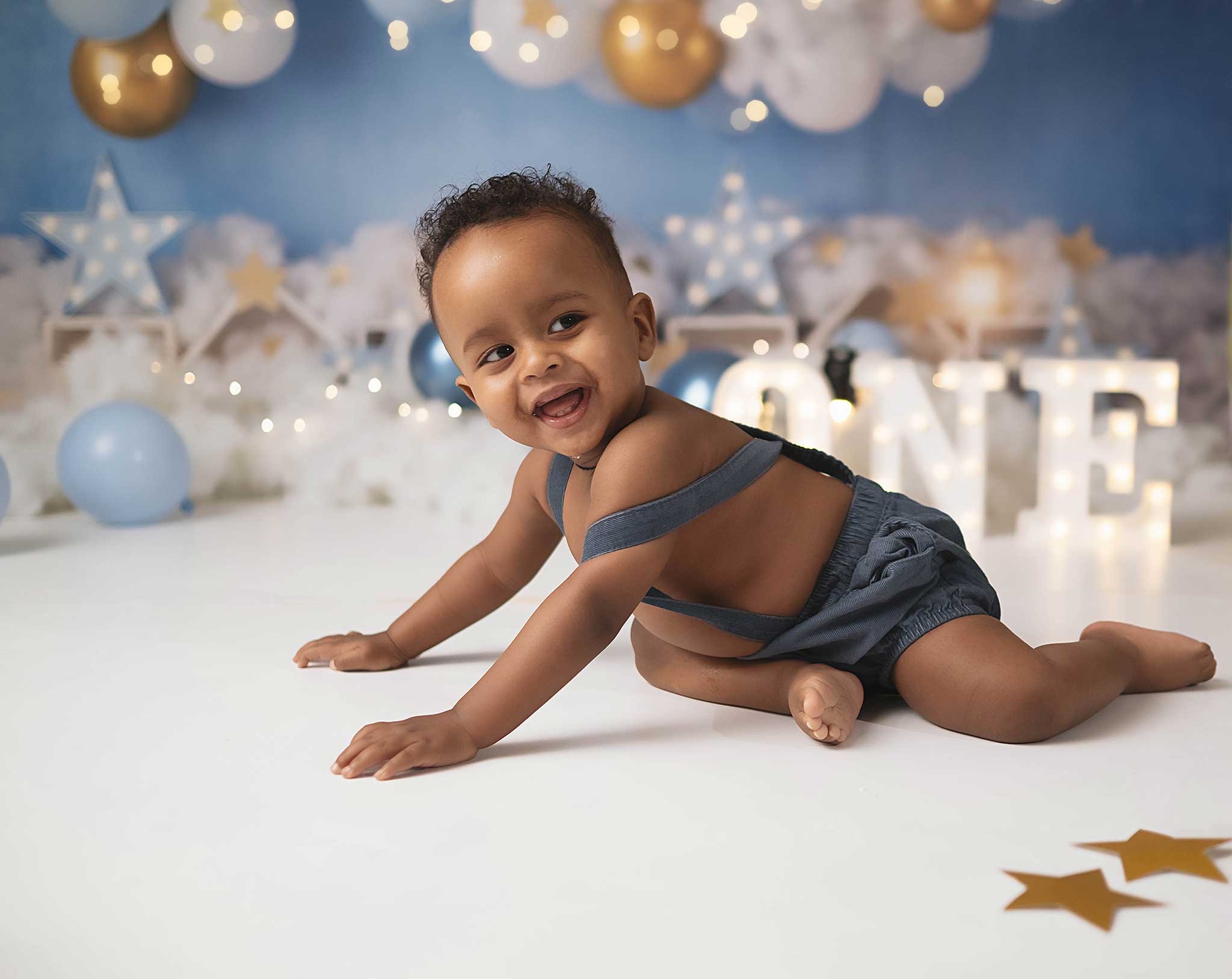baby boy doing a photoshoot to celebrate his first birthday