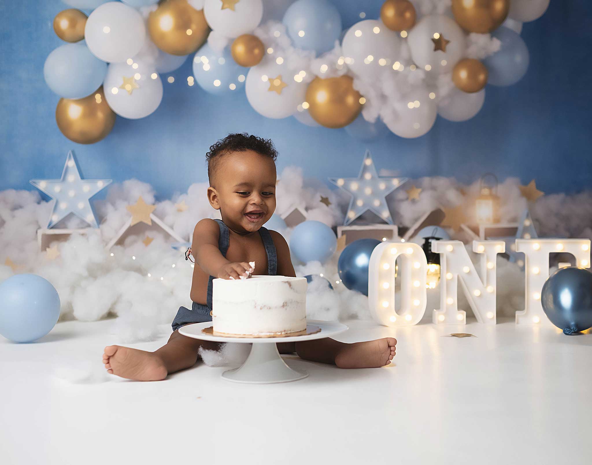 baby boy doing a photoshoot to celebrate his first birthday