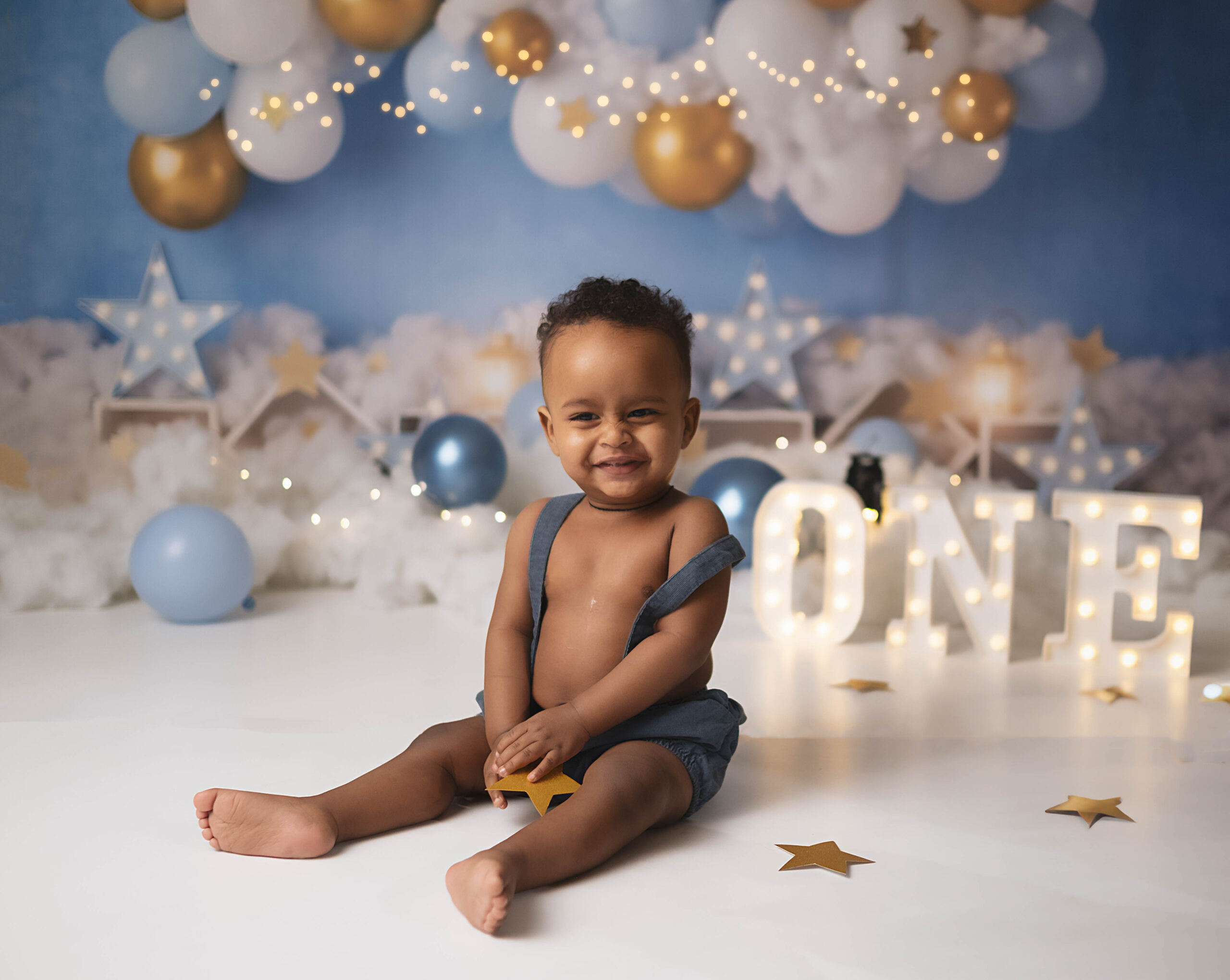 baby boy doing a photoshoot to celebrate his first birthday