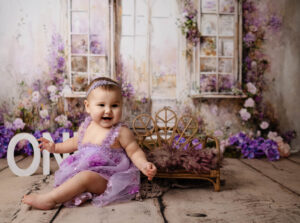 baby posing for her first birthday photoshoot, cake smash photos in Calgary studio