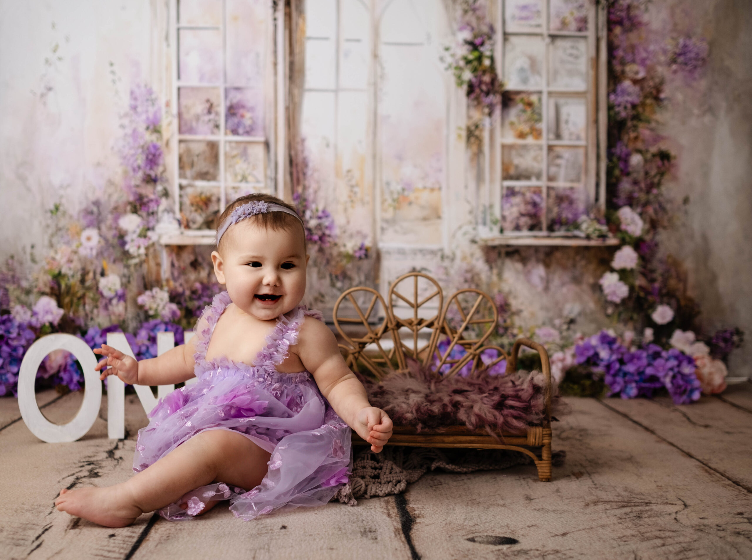 baby posing for her first birthday photoshoot, cake smash photos in Calgary studio