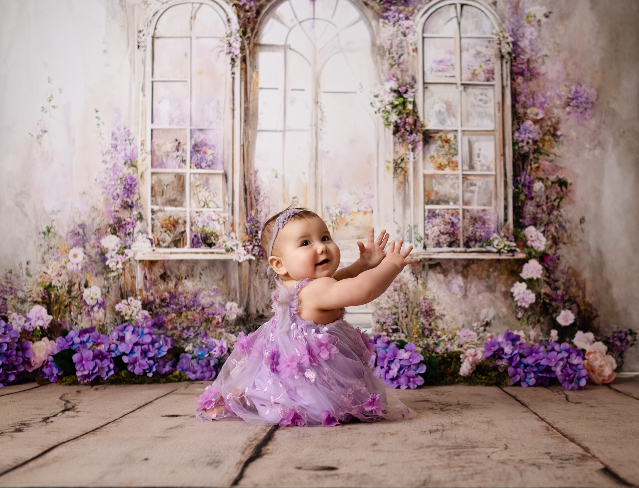 baby posing for her first birthday photoshoot, cake smash photos in Calgary studio
